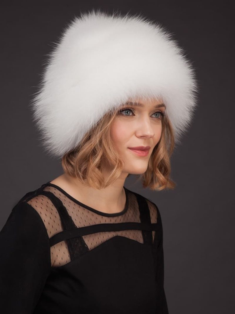 White fox fur hat with leather inserts and pom-pom