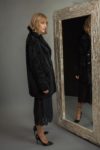 medium-length black sheepskin fur coat