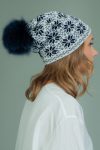 slouchy wool hat with fur pom-pom with dark blue star pattern in white background