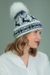 wool hat with fur pom-pom in dark blue Santa deer pattern in white background