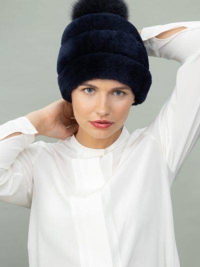 dark blue mouton fur hat with fox fur pom-pom